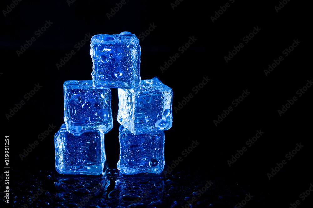 Blue ice cubes reflection on black table background. Blue ice cubes reflection on black table background.