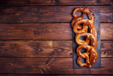 Top view of many pretzels on wooden background