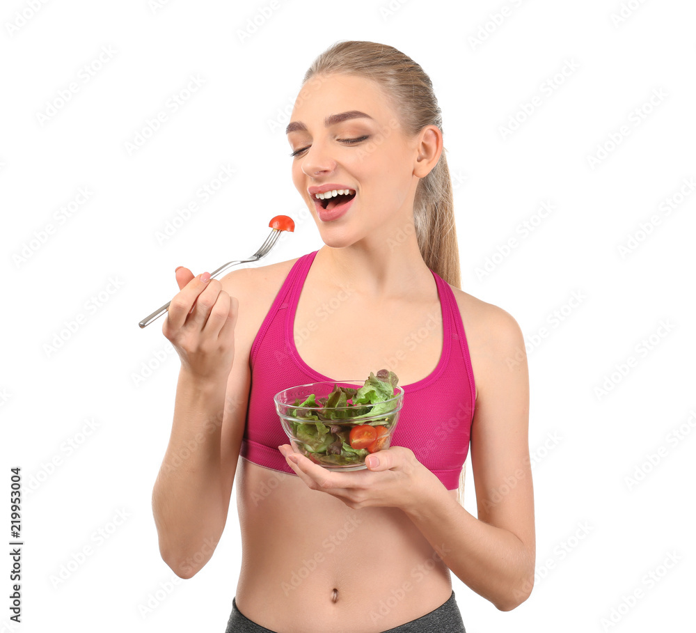 Young woman eating salad on white background. Diet food concept Young woman eating salad on white background. Diet food concept