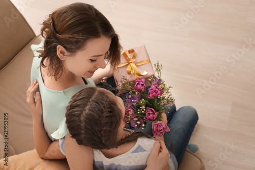 Little girl greeting her mother at home