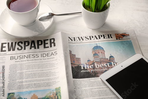 Newspaper with cup of tea a...