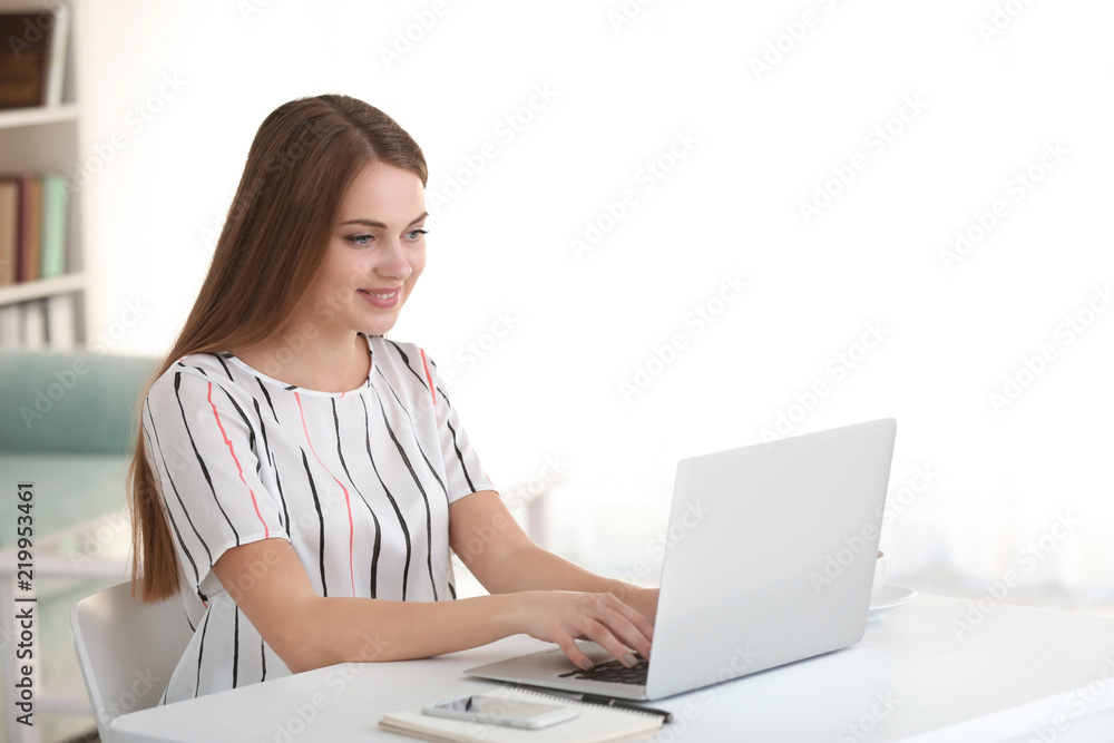 Female freelancer working on laptop in home office Female freelancer working on laptop in home office