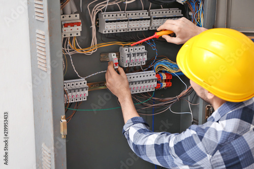 Electrician repairing distr...