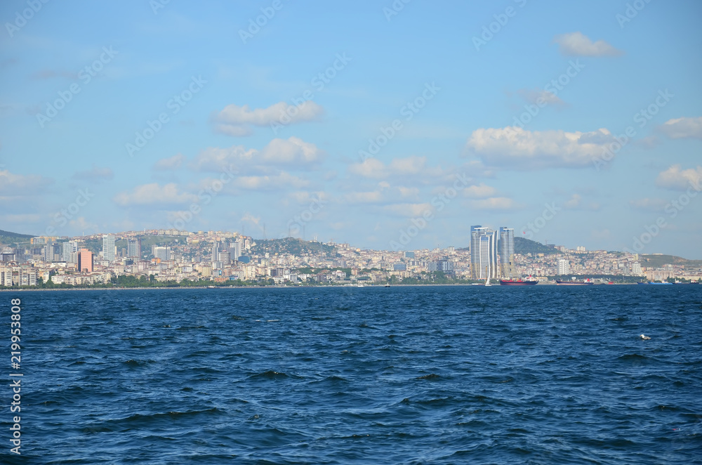 Fototapeta premium View to Istanbul from Prince's Islands (Büyükada). Sea cityscape with modern skyscrapers of Istanbul. Beautiful blue sky with white clouds