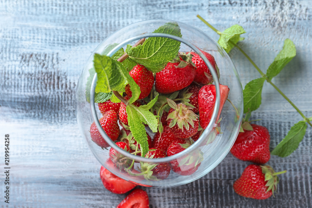 Glass bowl with ripe strawberries on wooden background Glass bowl with ripe strawberries on wooden background