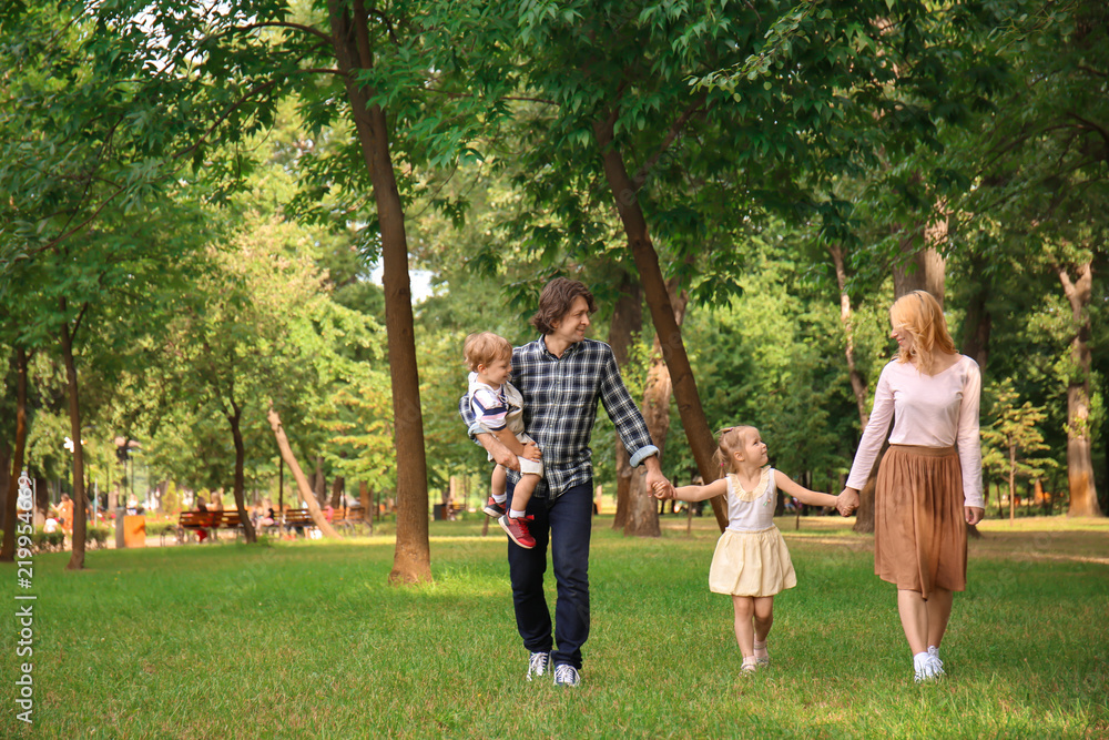 Happy family walking in green park