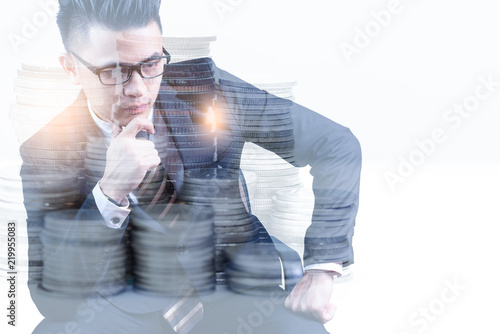 the double exposure image of businessman thinking overlay with coin stack and white copy space. the concept of accounting, business, financial, economy and investment.