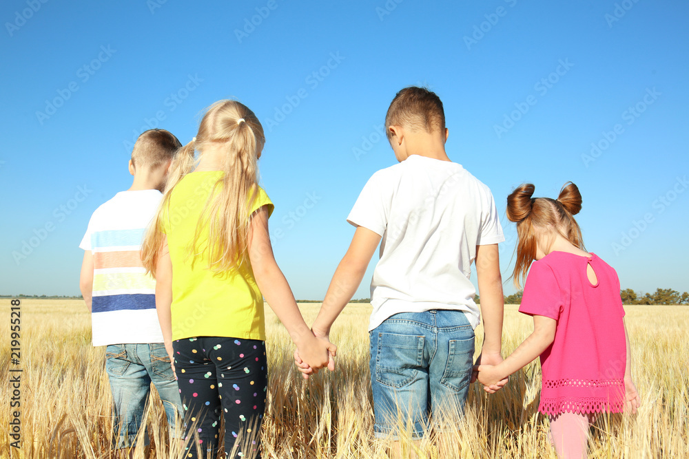 Cute little children in wheat field on sunny day - obrazy, fototapety, plakaty 