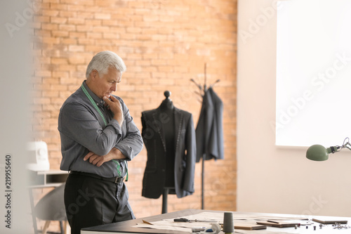 Mature tailor working with ...