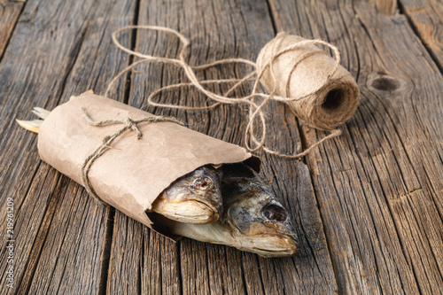 close-up dried fish on a dark wooden background photo