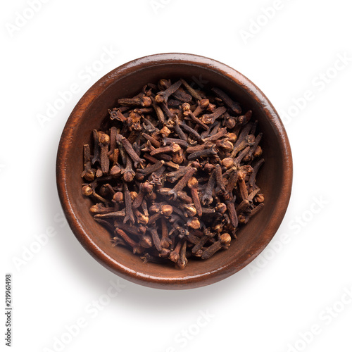 cloves in a wooden bowl, isolated on white