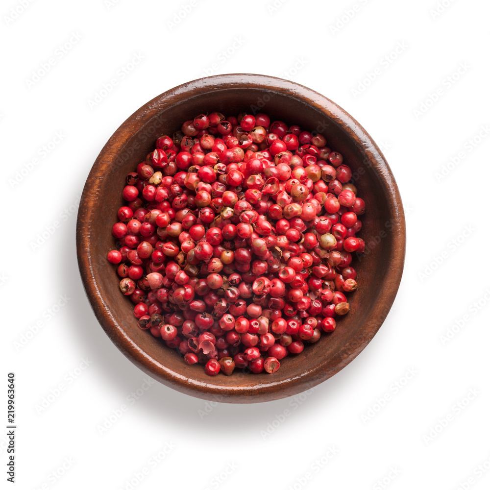 red pepper in a wooden bowl, isolated on white red pepper in a wooden bowl, isolated on white