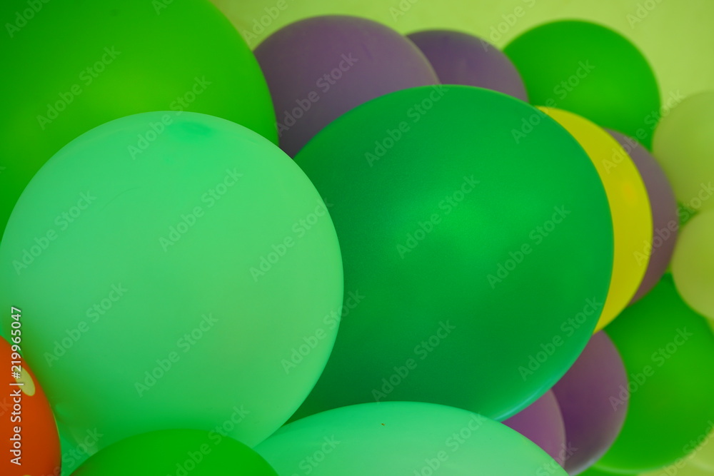 Colorful green and multicolor balloons at a party