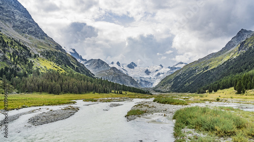 Mountain landscape in the Roseg valley below the melting glaciers and summits of the Sella Group and Piz Roseg