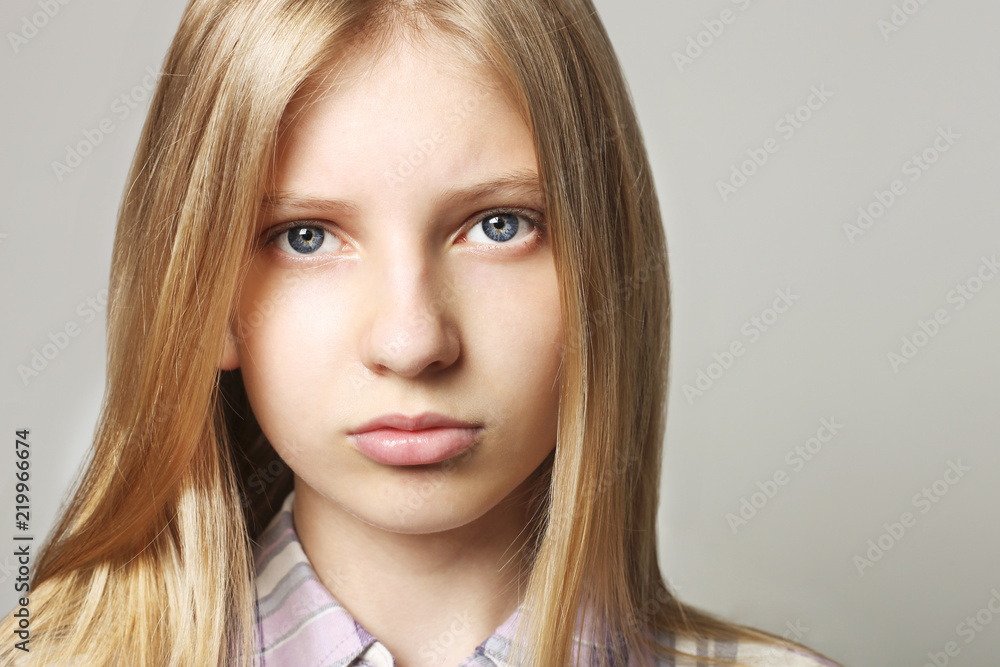 Close up portrait of beautiful teenager girl with sad depressed facial expression. Pretty young woman with long blonde hair looking stressed and worried. isolated background, copy space. Close up portrait of beautiful teenager girl with sad depressed facial expression. Pretty young woman with long blonde hair looking stressed and worried. isolated background, copy space.