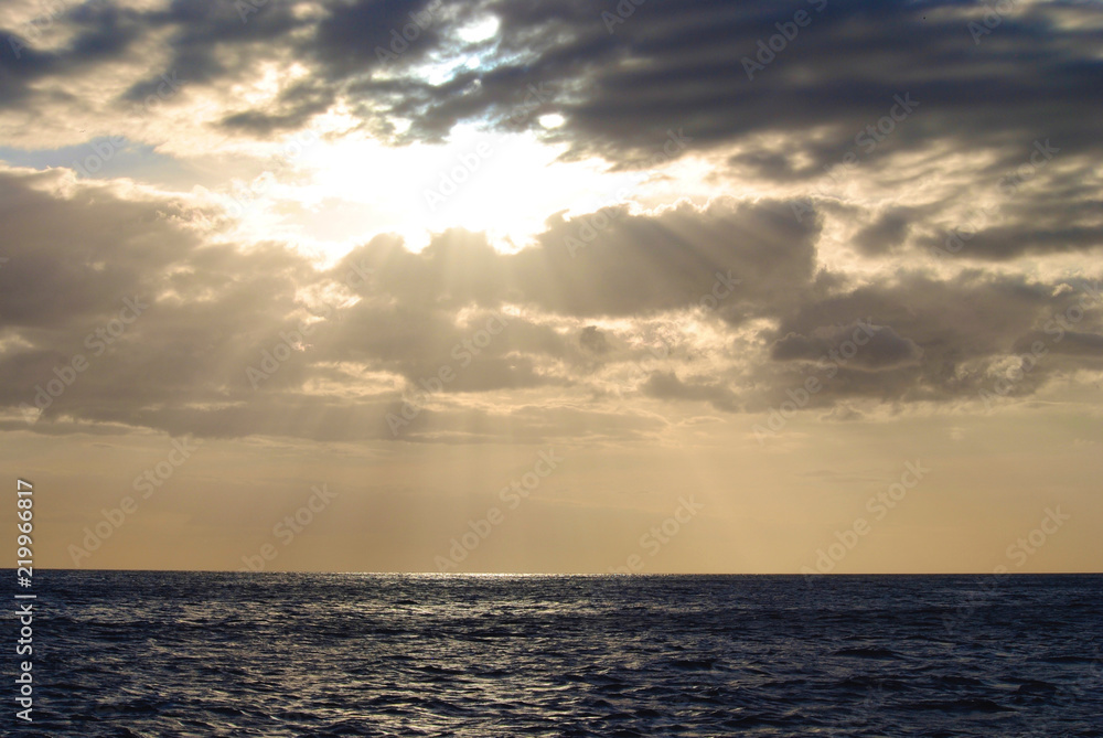 Sun Rays Through the Clouds over the Ocean