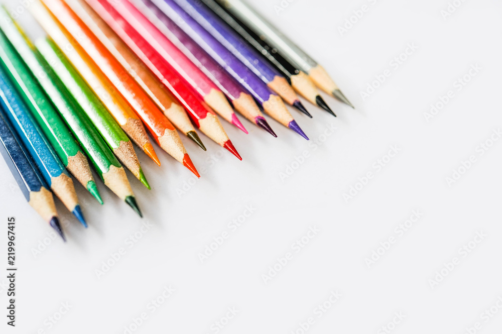 Colour pencil rainbow style,Scale colour of coulour pencil,Colour pencil lay on white paper with sunshine day,Selective focus Colour pencil rainbow style,Scale colour of coulour pencil,Colour pencil lay on white paper with sunshine day,Selective focus