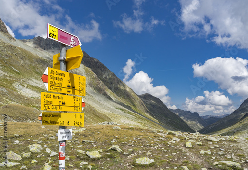 active senior woman, riding her e-mountainbike on the famous Suvretta Loop trail, high above Saint Moritz, Engadin, Switzerland photo