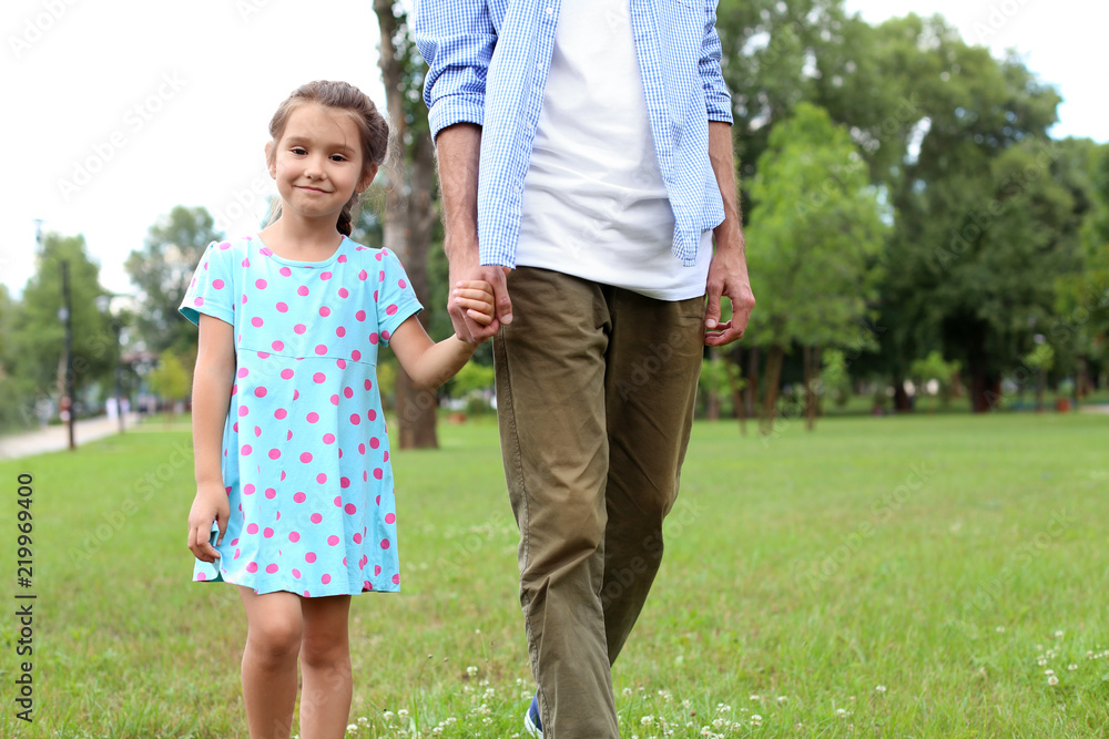 Little girl and her father walking outdoors Little girl and her father walking outdoors
