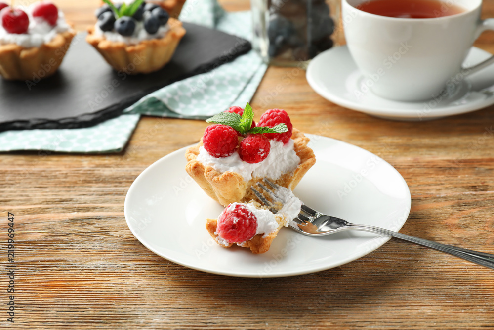 Tasty tartlet with raspberries on plate Tasty tartlet with raspberries on plate
