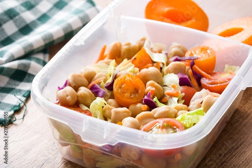 Lunch box with healthy food ready to eat.Chickpea salad on wooden table. 