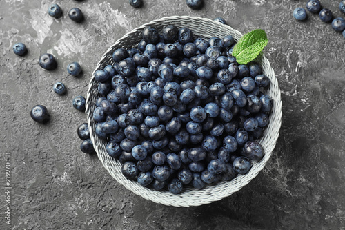 Bowl with ripe blueberries on grunge table