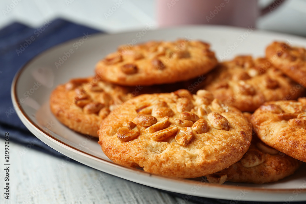 Plate with tasty cookies on wooden table, closeup