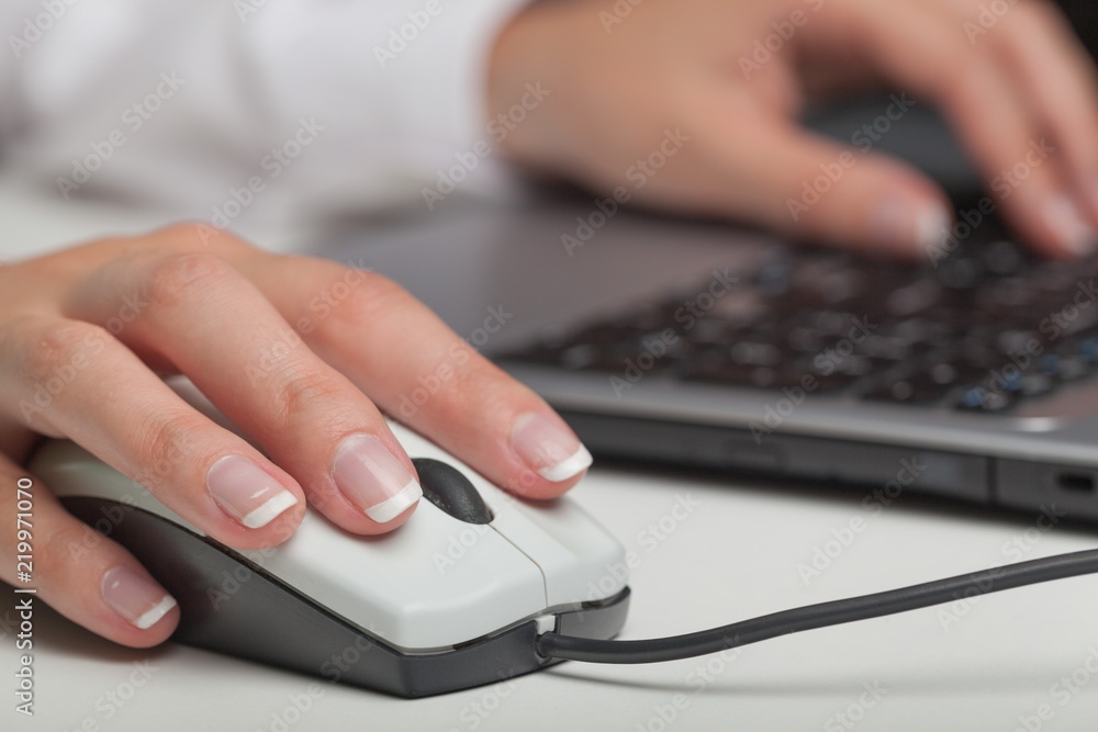 Closeup of Woman's Hands Using a Mouse while Typing Closeup of Woman's Hands Using a Mouse while Typing