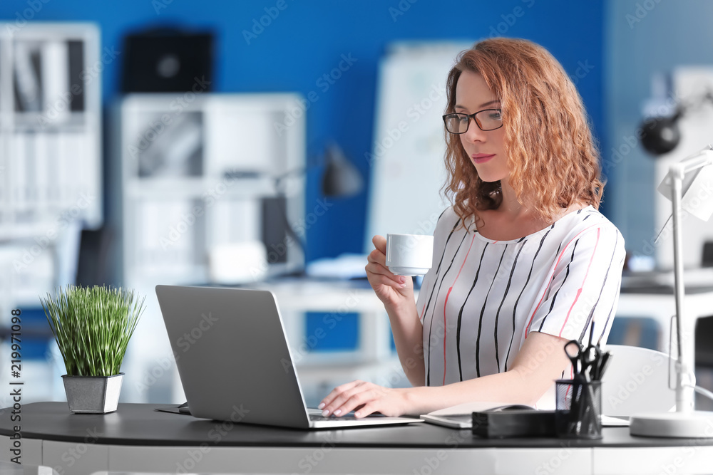 Successful businesswoman drinking coffee in office Successful businesswoman drinking coffee in office