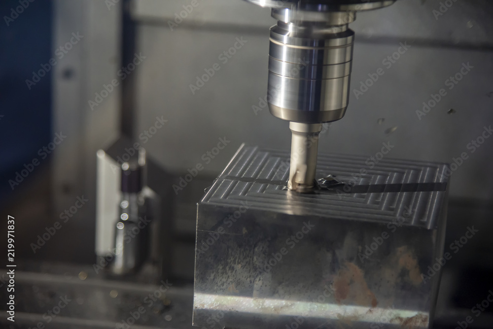 The CNC milling machine cutting the mold part in roughing process with the index-able radius endmill tool.Hi-technology manufacturing process. The CNC milling machine cutting the mold part in roughing process with the index-able radius endmill tool.Hi-technology manufacturing process.