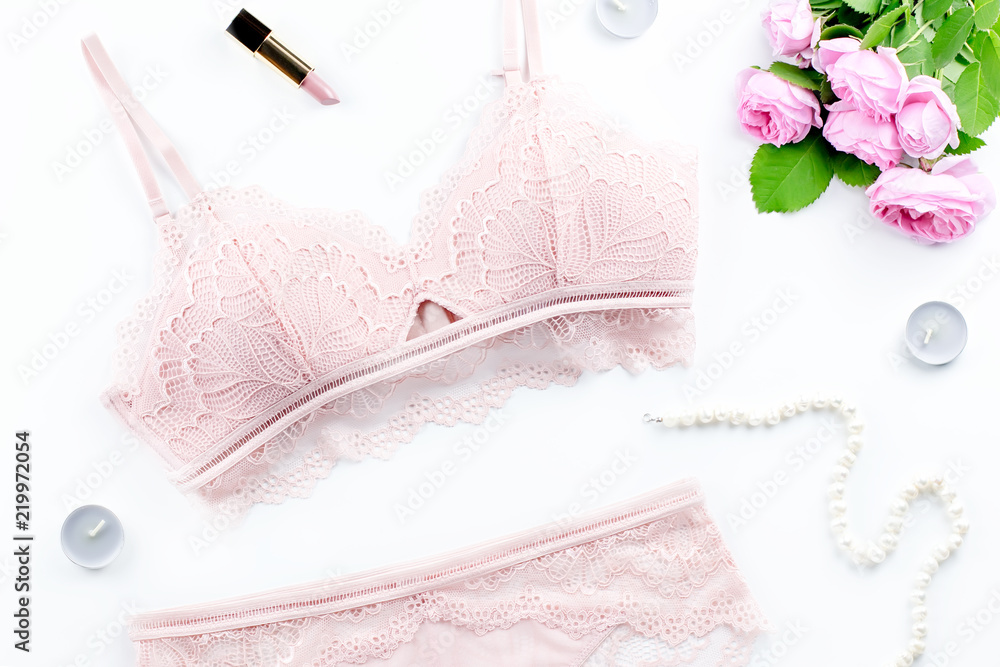 Woman elegant pink lace bra and panties, flowers, jewelry. Stylish lingerie flat lay. Underwear fashion concept Woman elegant pink lace bra and panties, flowers, jewelry. Stylish lingerie flat lay. Underwear fashion concept