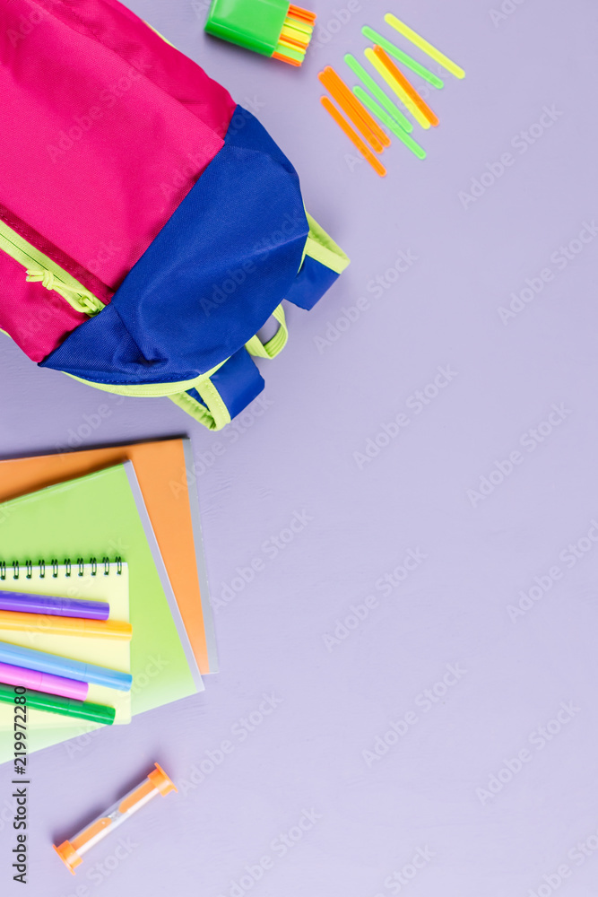 Fototapeta premium School concept flat lay. Kid backpack, notebook, markers on wooden desktop