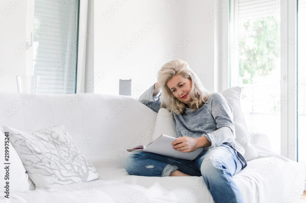 Adult woman sitting and reading book Adult woman sitting and reading book