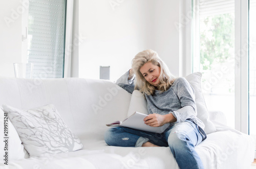 Adult woman sitting and reading book
