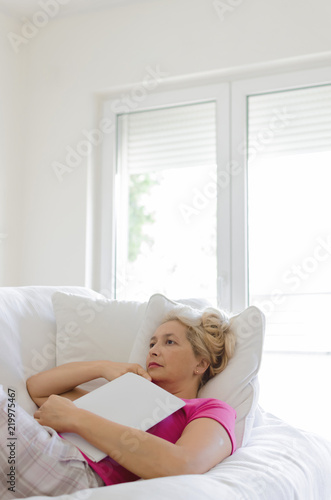 Senior woman relaxing in livingroom