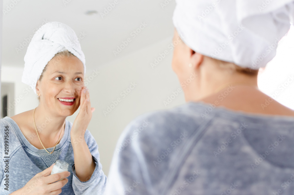 Woman applying face cream Woman applying face cream