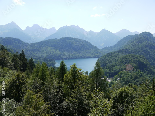 Fototapeta Naklejka Na Ścianę i Meble -  simple mountain landscape with a lake partly hidden by dense forest 