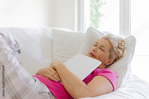 Woman sleeping with book in hands