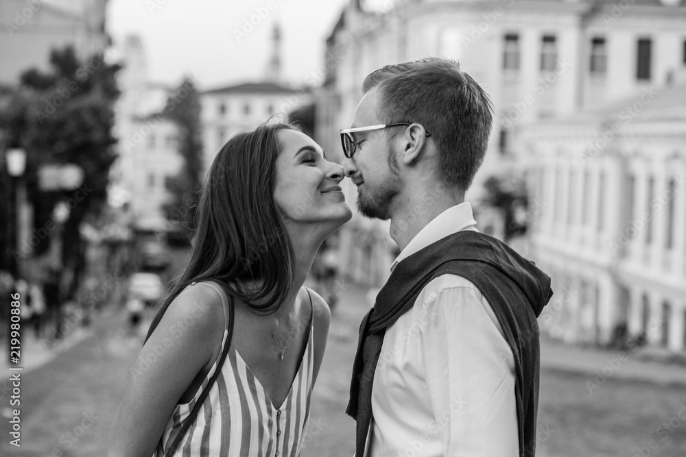 Obraz premium A loving couple on a walk in the city touch each other's noses