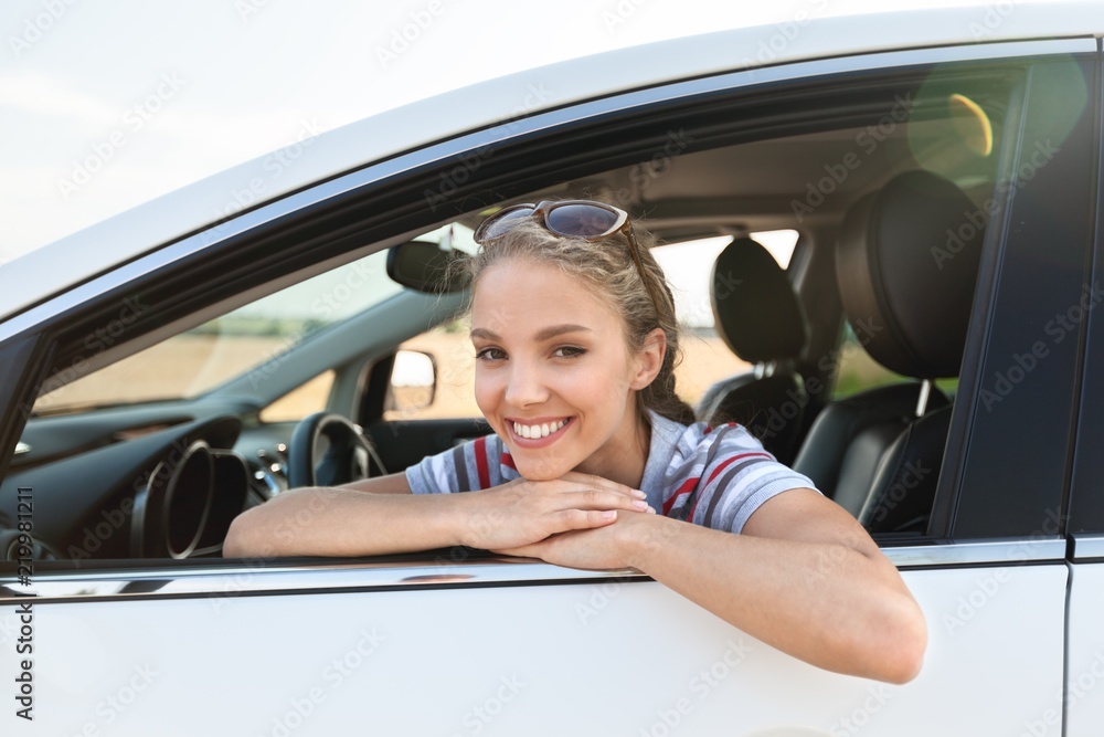 Portrait of Smiling Young Woman in her Car