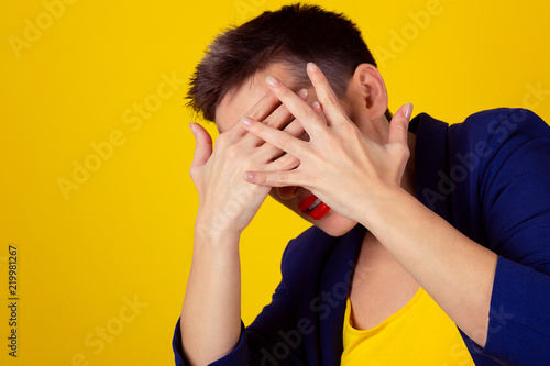Woman hiding face eyes behind her hands