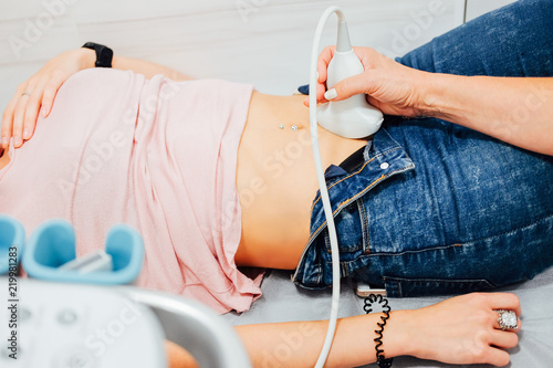 Woman at gynecologist doing ultrasound skan photo