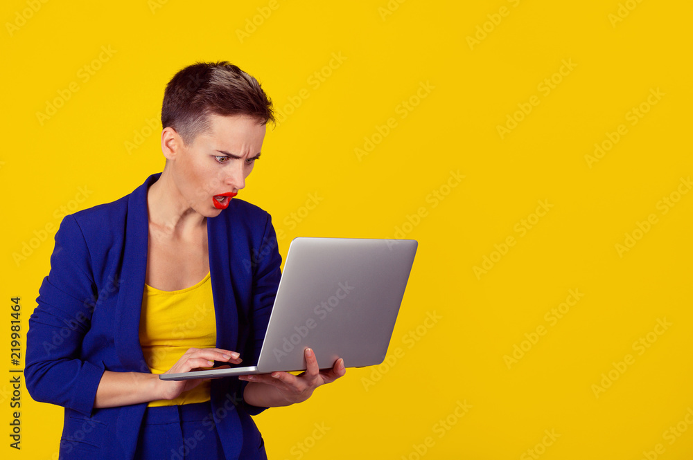 woman using laptop looking at computer screen blown away in stupor woman using laptop looking at computer screen blown away in stupor
