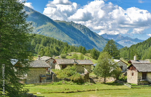cottage in the valley next to alpine glacier in summer