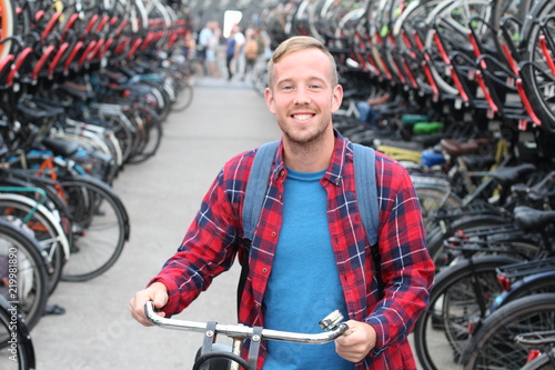 Joyful blonde man in bicycle 3D parking lot