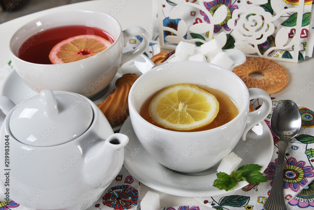 various cookies and biscuits baked at home in a container and tea in a retro cup with free space for text various cookies and biscuits baked at home in a container and tea in a retro cup with free space for text