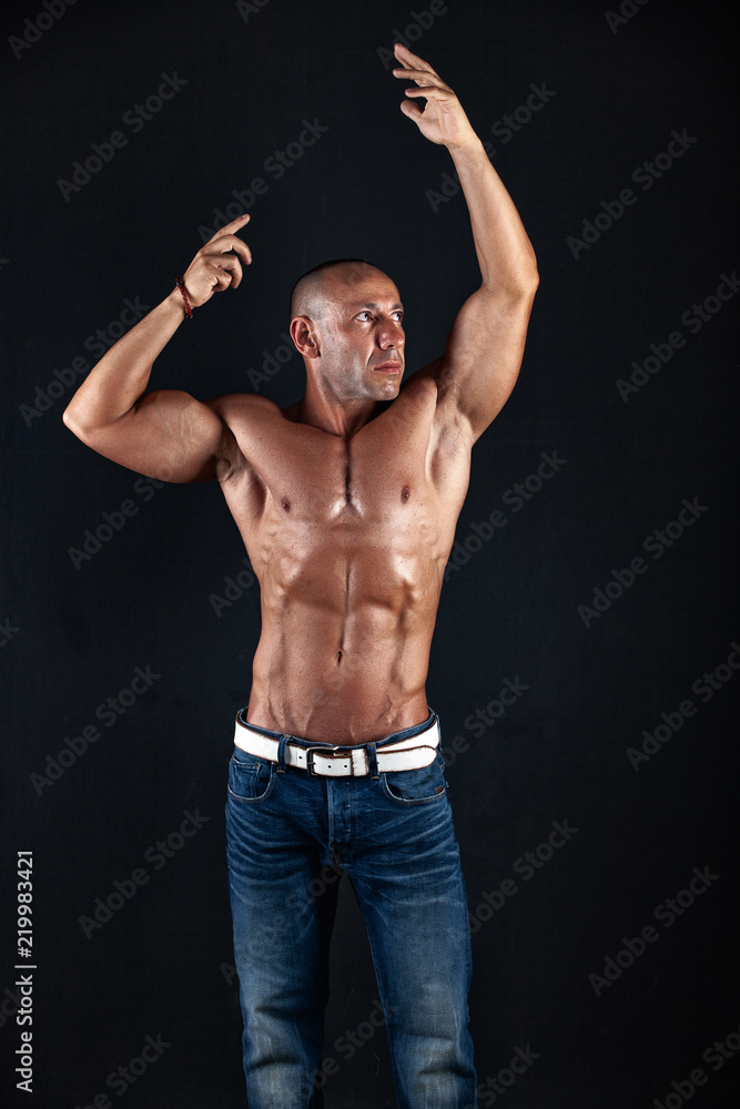 Fototapeta premium very muscular handsome athletic man on black background