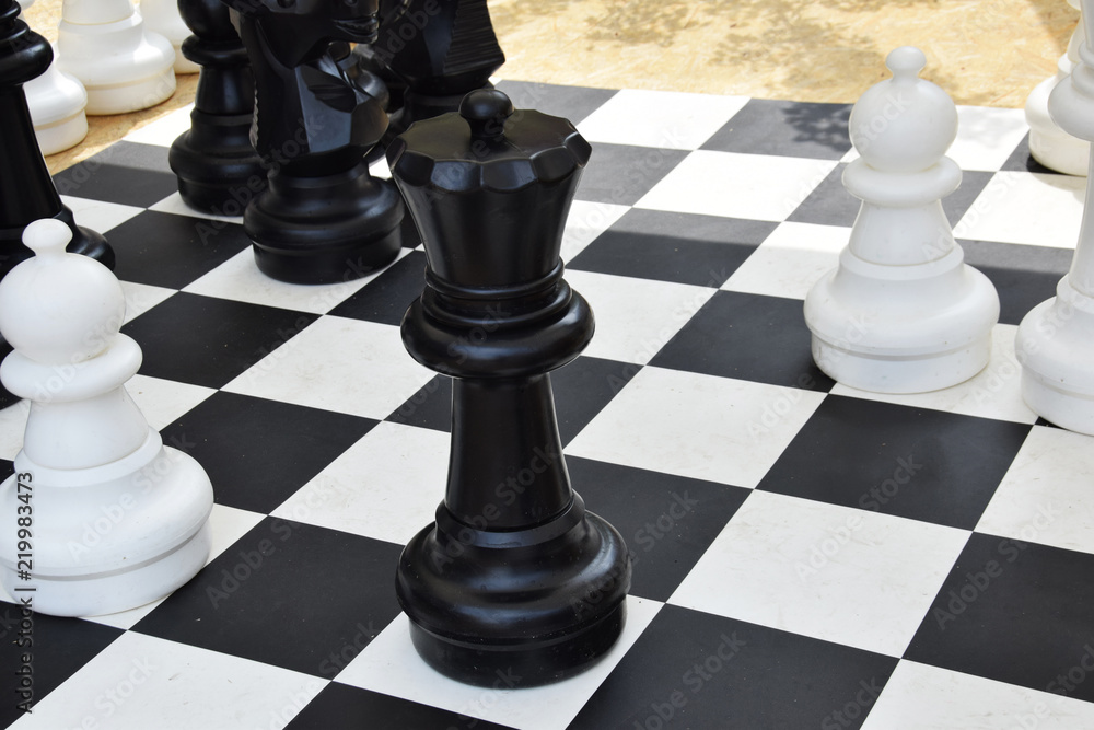giant chess on the board located on the ground giant chess on the board located on the ground