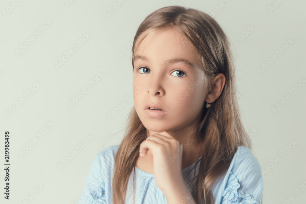 the child in the Studio posing in fashionable clothes the child in the Studio posing in fashionable clothes