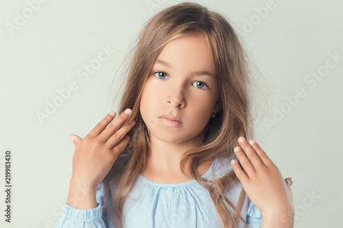 the child in the Studio posing in fashionable clothes